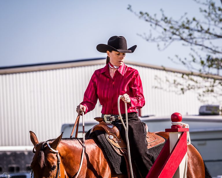 Cowgirl riding horse in competition