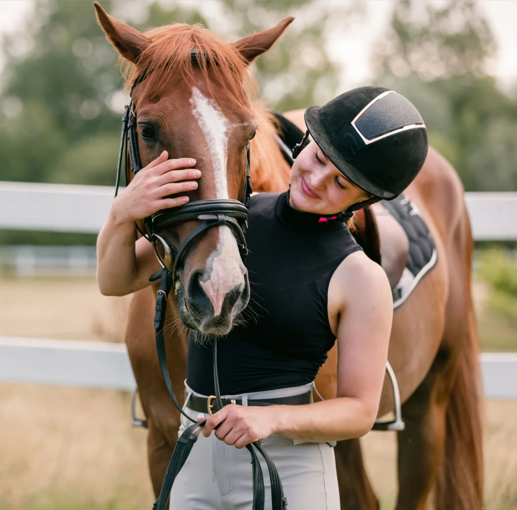 Rider caressing her horse